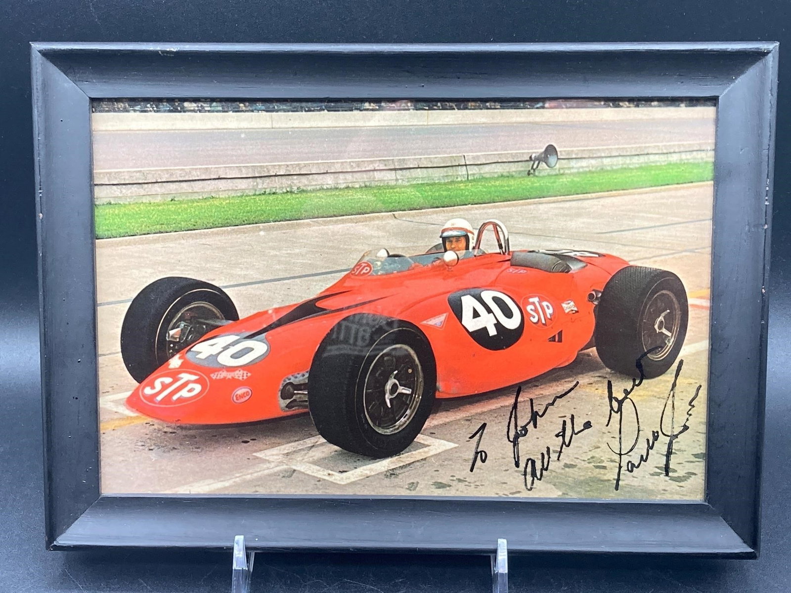 1967 Indy 500 Parnelli Jones Signed: Parnelli Jones signed 1967 Indy 500 photo of Jones in his #40 STP car. Color photo measures 6x9". Personalized signature at bottom noted in photos. Photo is in excellent condition.
