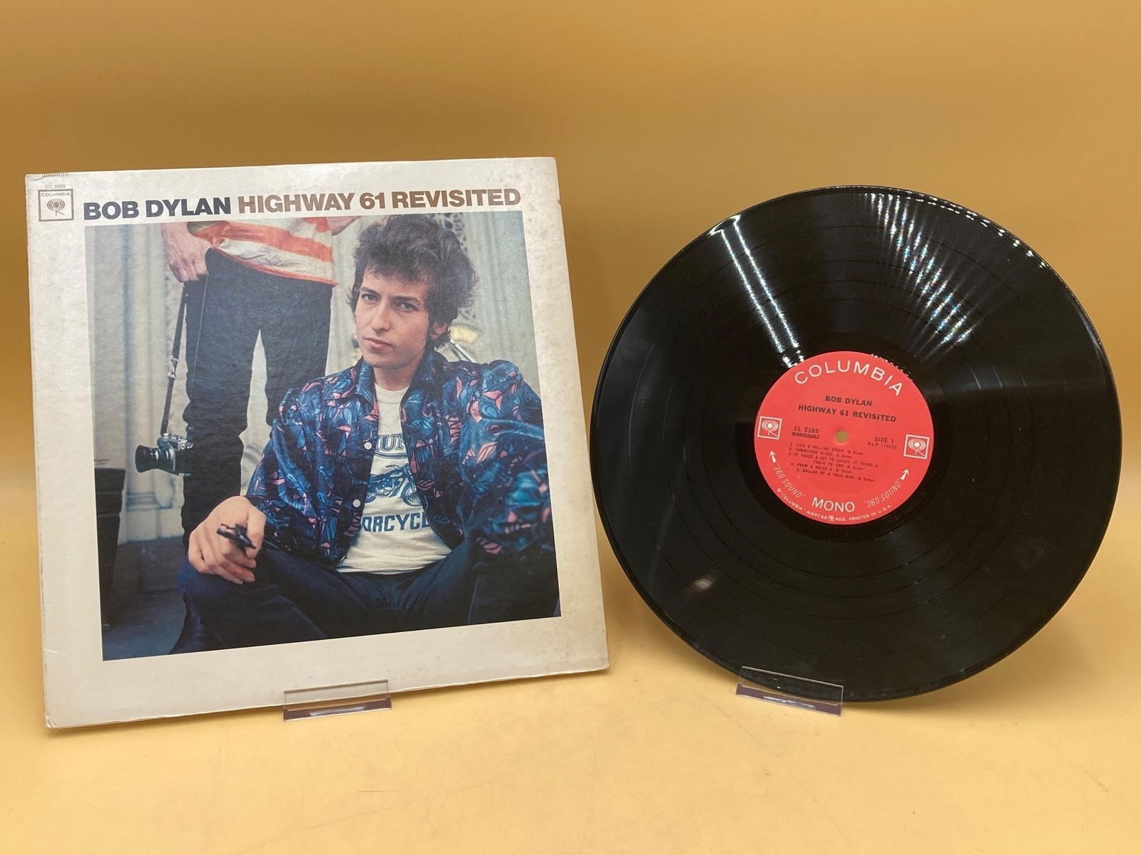 Bob Dylan Highway 61 CL 2389 Vinyl Album: Original 1965 Bob Dylan Highway 61 revisited CL-2389 first pressing vinyl album. Sleeve has some light stains and wear, vinyl album has one spot of wear as noted in photos. Does not have paper vinyl l