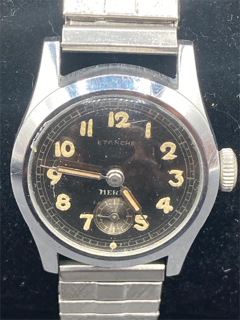 Vintage Etanche Swiss Military Watch: Vintage Etanche Swiss military watch. Made circa World War II. Elastic band with engravings on underside and Swiss maker mark on battery cover. Watch is untested and will need battery replacement. Sma