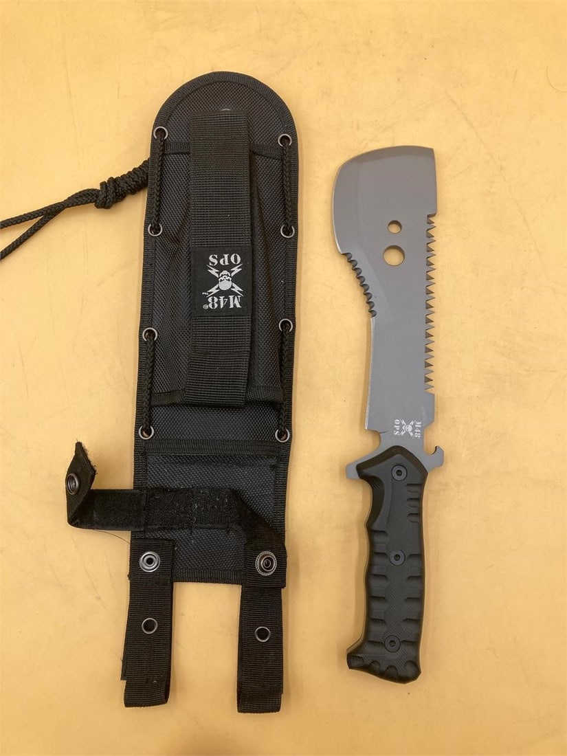 United Cutlery M48 Ops UC3118 Smatchet Knife: United Cutlery M48 Ops tactical smatchet knife model UC3118 with carrying case. Knife features sawtooth serrated edge, machete style head, and full tang blade. Blade measures 8", total length measures