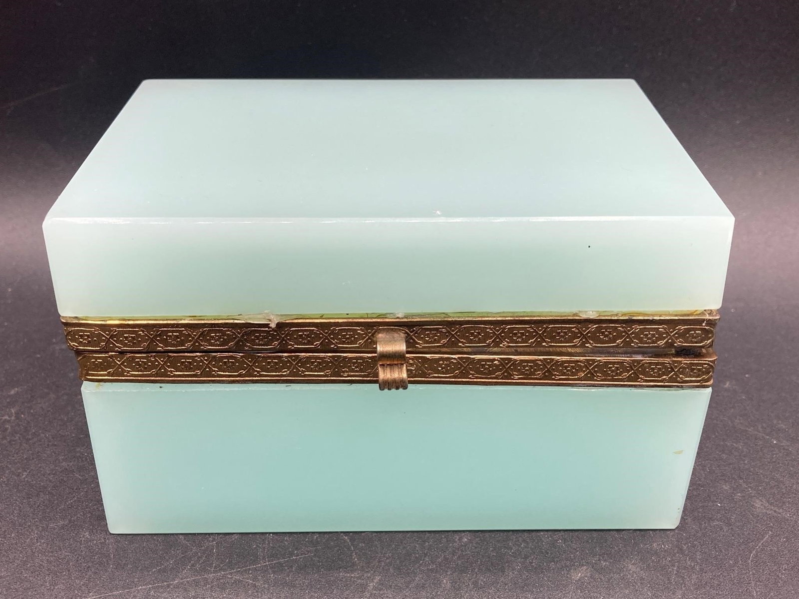 French Opaline Glass Dresser Box: Vintage French opaline glass dresser box. Opal one glass base and top with brass hinges and accent border. Glue lines are visible where glass is attached to brass, otherwise box is in good condition.M