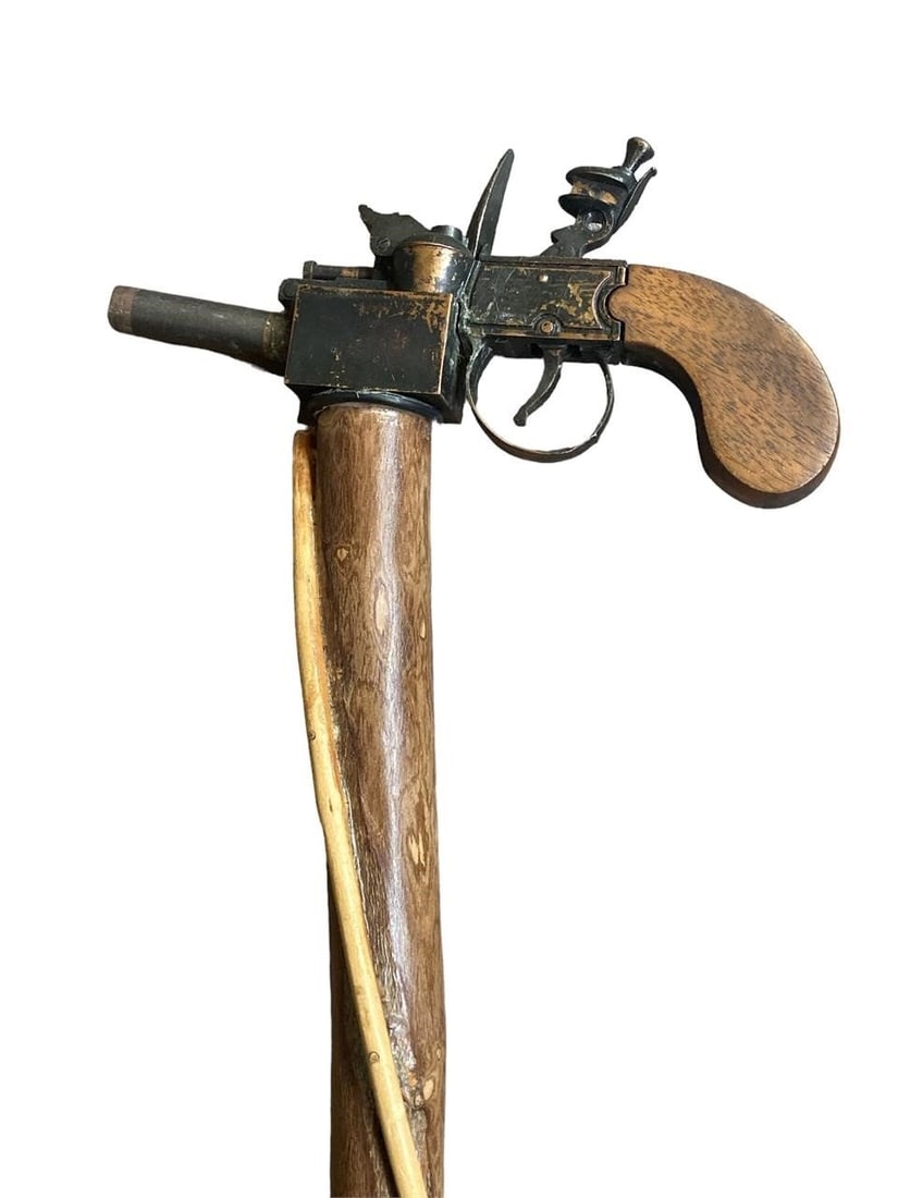 Flintlock Pistol Replica Walking Stick: Hand made flintlock pistol replica walking stick. Top features a modified replica flintlock pistol that will not fire rounds but has working mechanism to display how the pistol used to work. Natural w