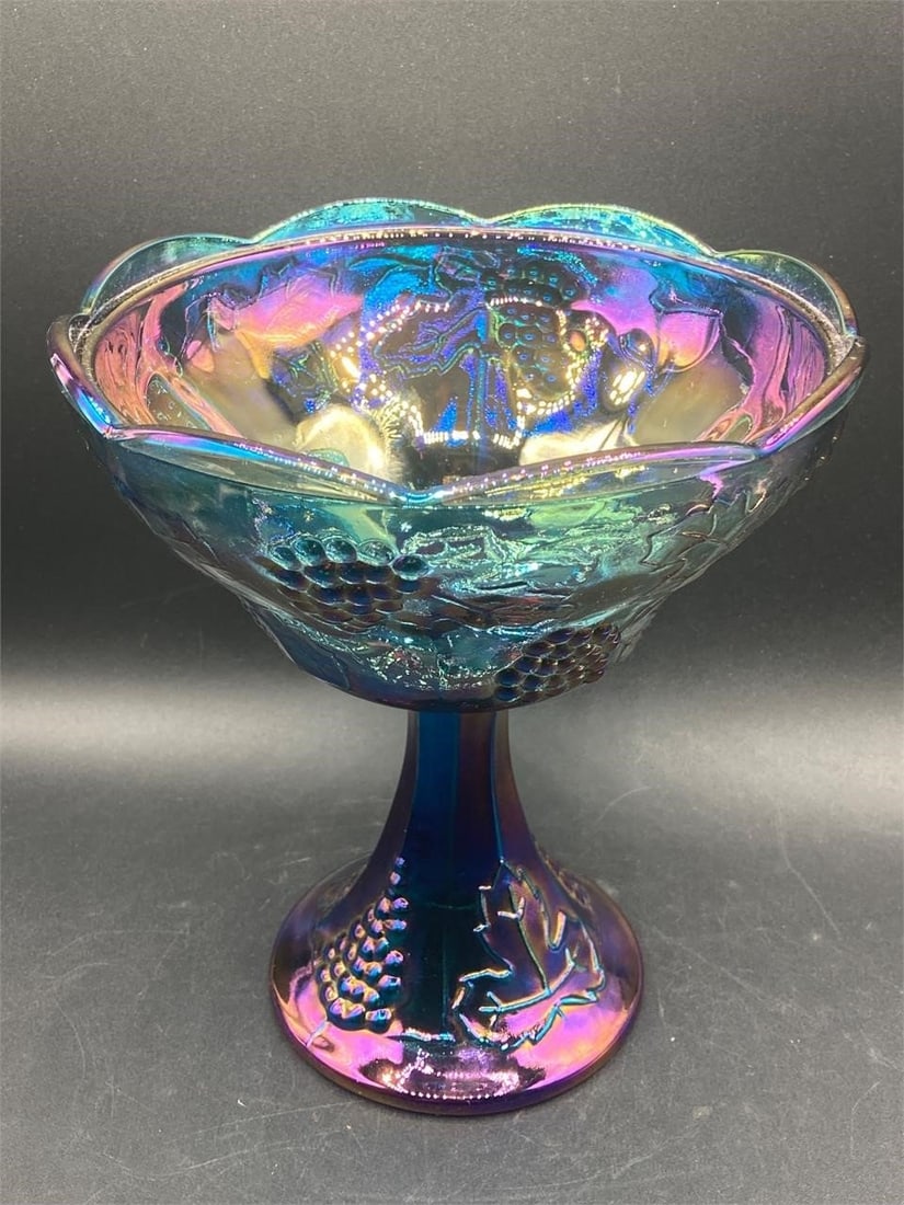 Indiana Glass Iridescent Blue Grapes Compote: Vintage Indiana glass iridescent blue grapes harvest compote. Features grapes and leaves designs on glass that changes colors under different lighting. Measures 7 1/2" tall. Good condition.Measurement