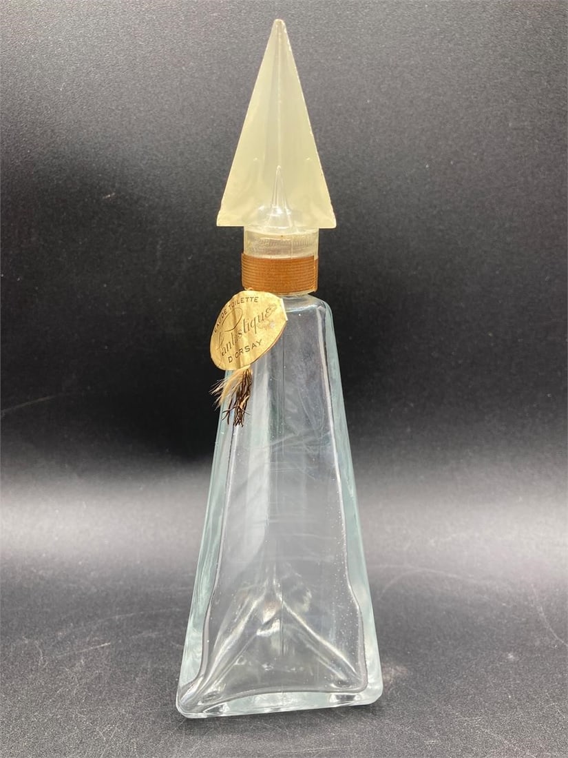 Vintage D'Orsay Fantastique Perfume Bottle: Vintage 1950s D'Orsay Fantastique perfume bottle with original tag. Features iridescent glass that changes colors under different lighting and pyramid shaped screw cap. Measures 7" tall. Bottle is in 