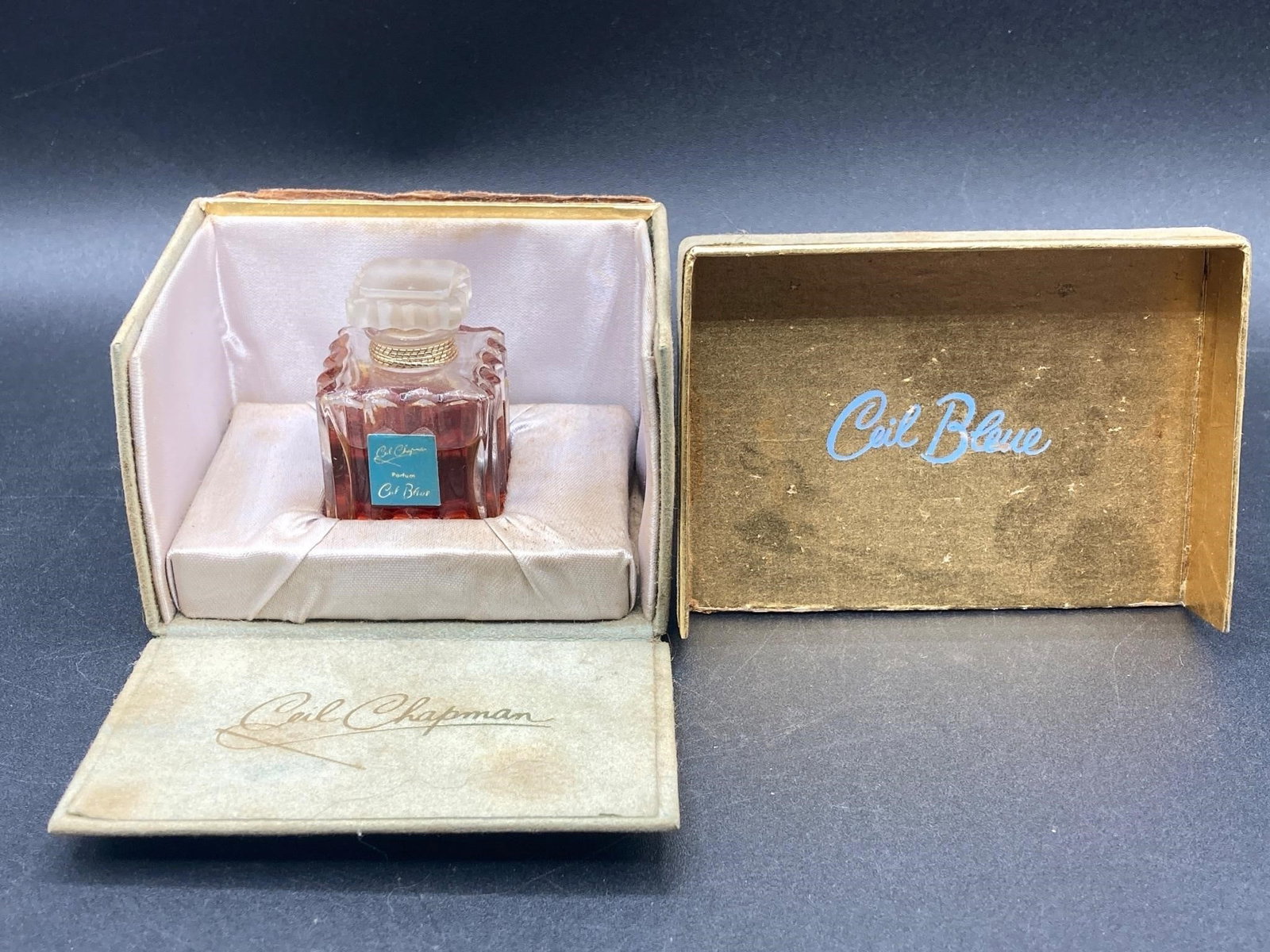 Vintage Ceil Chapman Ceil Bleue Perfume: Antique Ceil Chapman Ceil Bleue 10ml perfume with original felt box. Bottle features frosted glass stopper, gold tone string roping and well preserved original label. Box features green felt exterior