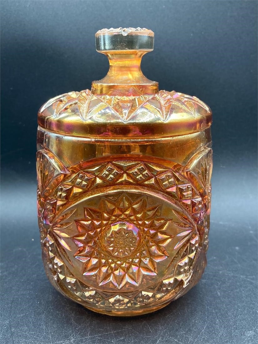 Imperial Glass Marigold Hobstar Cookie Jar: Vintage imperial glass iridescent marigold hobstar cookie jar. Features large hobstar medallion and diamond patterns on glass that changes colors under different lighting. Measures 6" tall. Jar is in