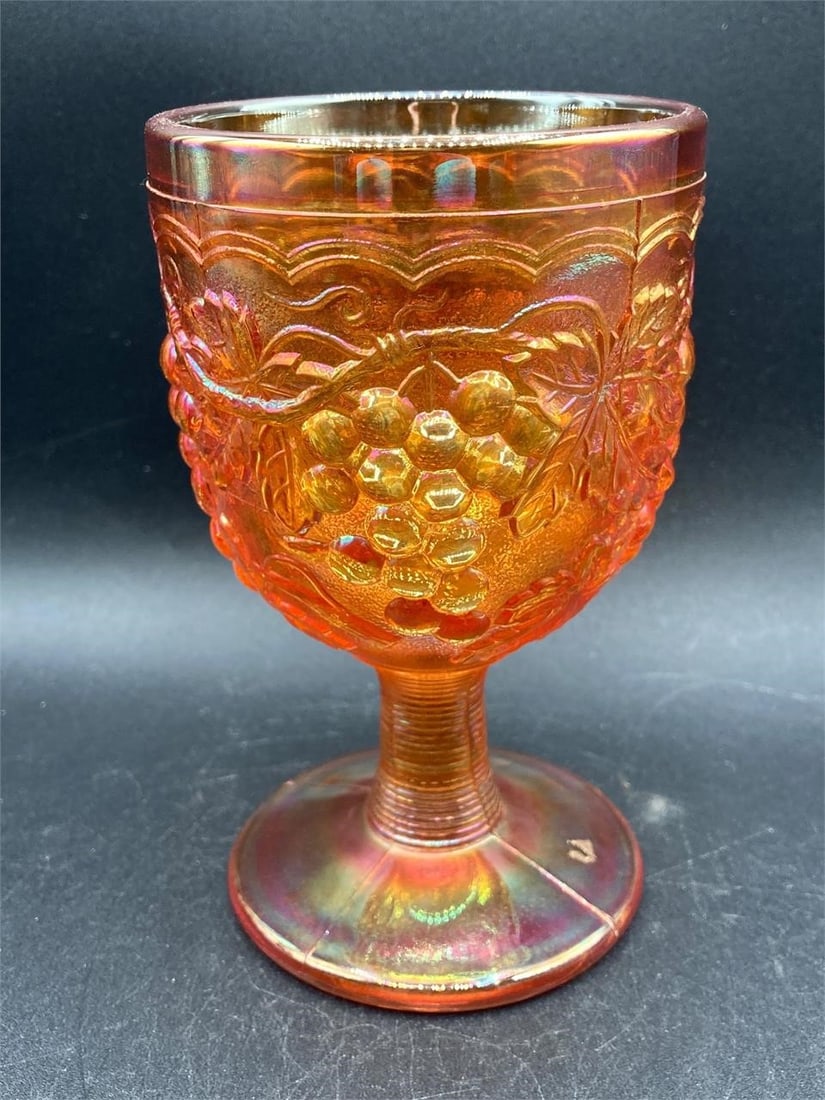 Vintage imperial glass iridescent marigold grape & cable goblet. Features grapes and leaves patterns: Vintage imperial glass iridescent marigold grape & cable goblet. Features grapes and leaves patterns on glass that changes color under different lighting. Measures 5.5" tall. Goblet is in excellent co