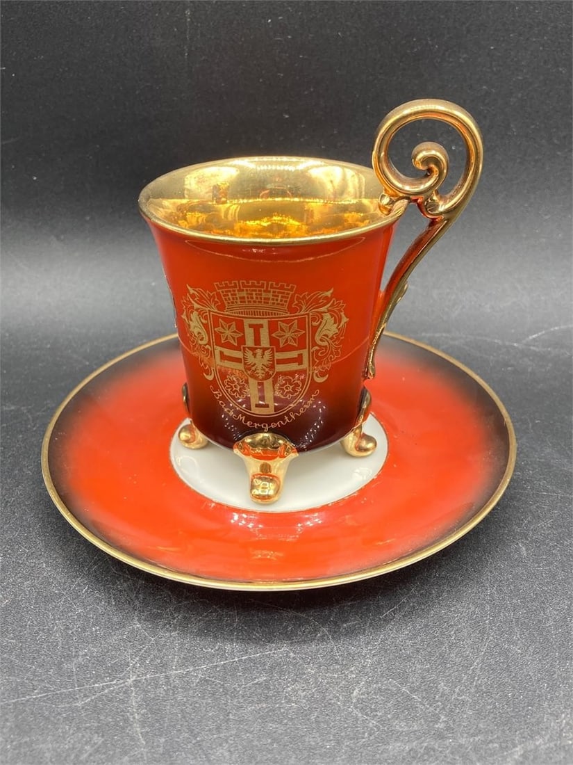 PWB Bavaria Demitasse Cup & Saucer: PWB Bavaria demitasse cup & saucer. Porcelain with gold tone and red colored marbled pattern paint and image of Schloss Neuschwanstein Castle on cup. Cup measures 3.25" tall. Some light wear to paint