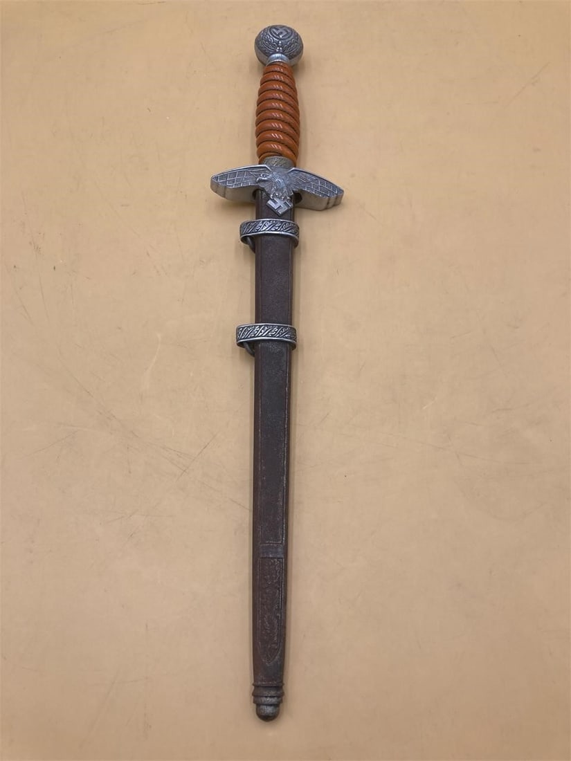 Solingen WWII German Officer Dagger: Solingen world war II German Heer Officer's dagger with scabbard. Bright orange colored handle with eagle hilt and reich stamps. Solingen stamp noted near hilt. Dagger measures 16" long, 11" blade. Sc