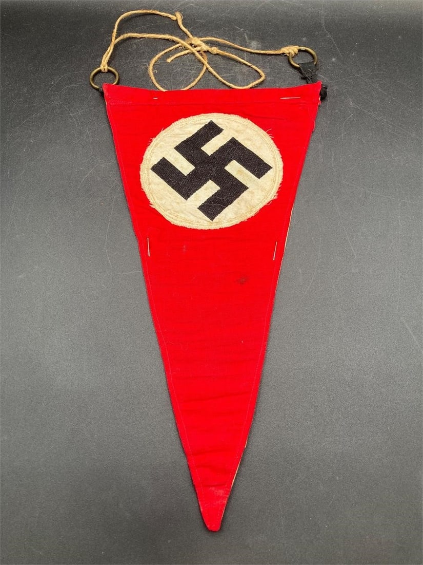 Original German WWII NSDAP Pennant: Original German world war II NSDAP pennant. Cotton material with stitched, prominent NSDAP symbol and brass ring hangers. Measures 11.5" long and 6 3/8" wide. Some light wear and one small stain noted