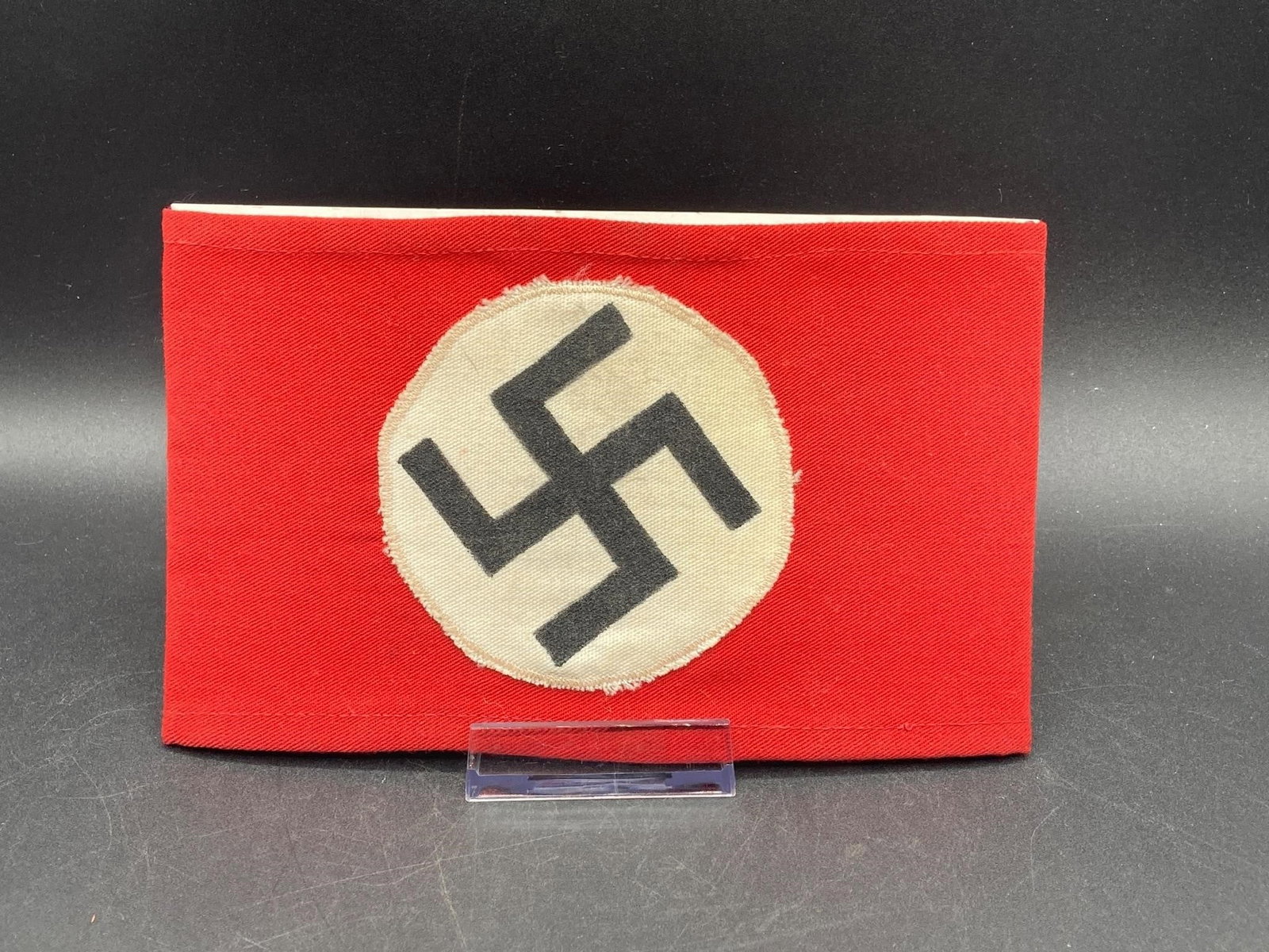 Original German WWII NSDAP Armband: Original German world war II NSDAP armband. Cotton material with prominent NSDAP symbol stitched on center. Maker stamp on back noted in photos. Measures 7 3/4" long. Item is in excellent condition.Me