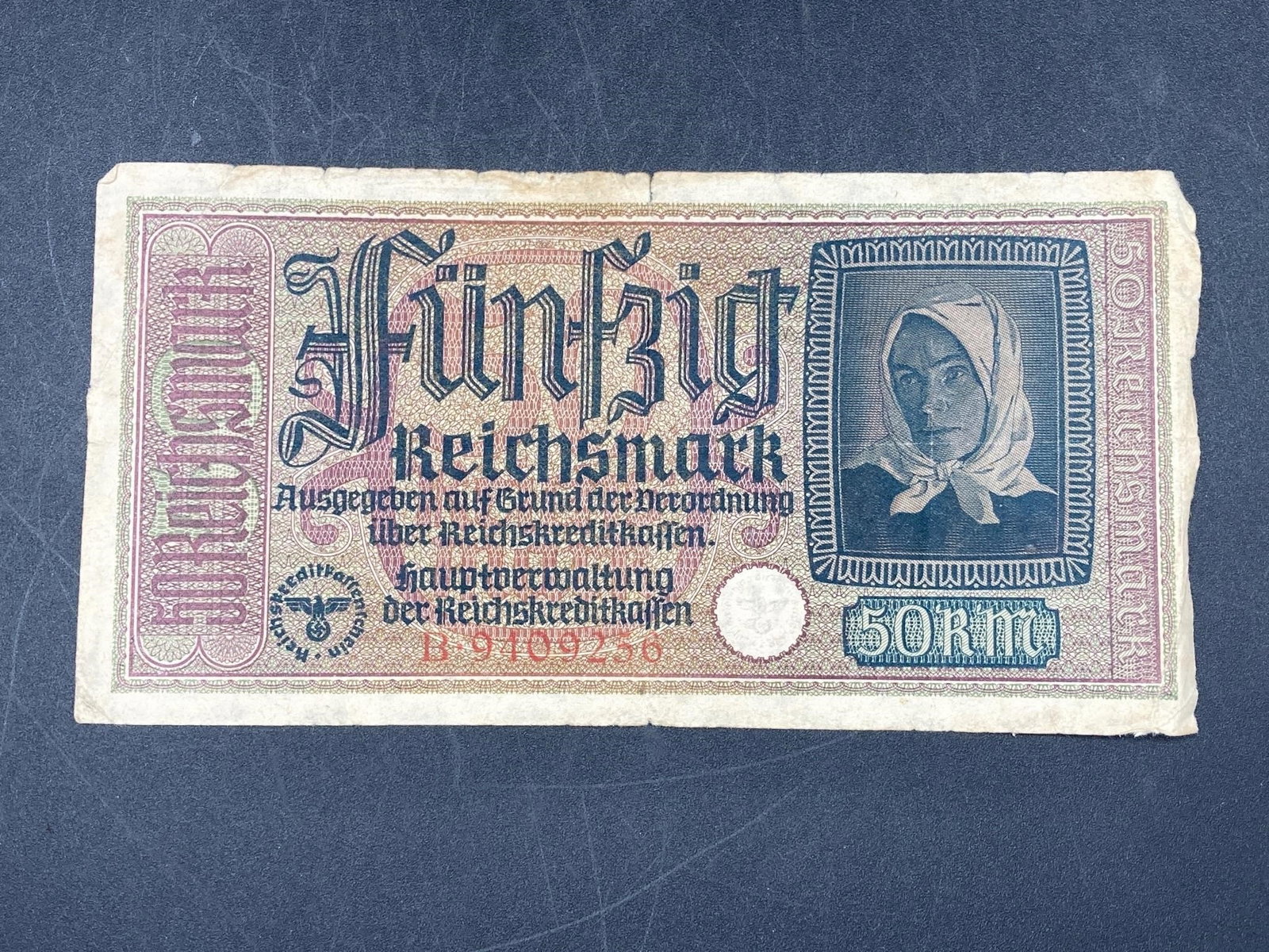 1940 Germany 50 Reichsmark Note: 1940 Germany 50 Reichsmark bank note. Ungraded, bill has light crease, worn edge and some light wear.Measurements: 3" W, 7" L, 1" H, 1 pound