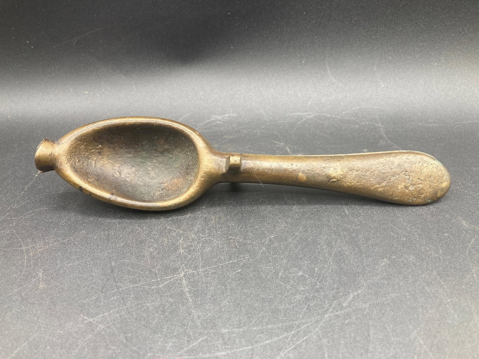 18th Century German Bronze Spoon Mold: Antique German bronze spoon mold. Heavy cast bronze with detail marks, used for shaping hot liquid metal for spoons. Measures 8" long. Excellent condition.Measurements: 2" W, 8" L, 1" H, 1 pound
