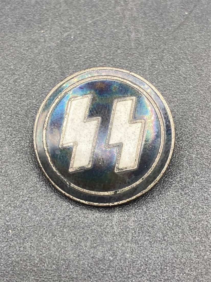 German WW2 Waffen SS Lapel Pin: German Waffen SS lapel pin. Enameled front with black and white color and prominent SS symbol. Measures 7/8". RZM and GES GESCH stamps noted in back. Some corrosion on back, otherwise pin is in good c