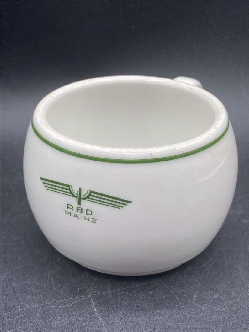 German WWII Deutsche Arbeits Front Coffee Mug: German world war II era Deutsche Arbeits Front porcelain mess hall coffee cup. RBD Mainz stamp on front of cup, Deutsche Arbeits Front maker stamps noted in noted on bottom. One small chip noted on ri