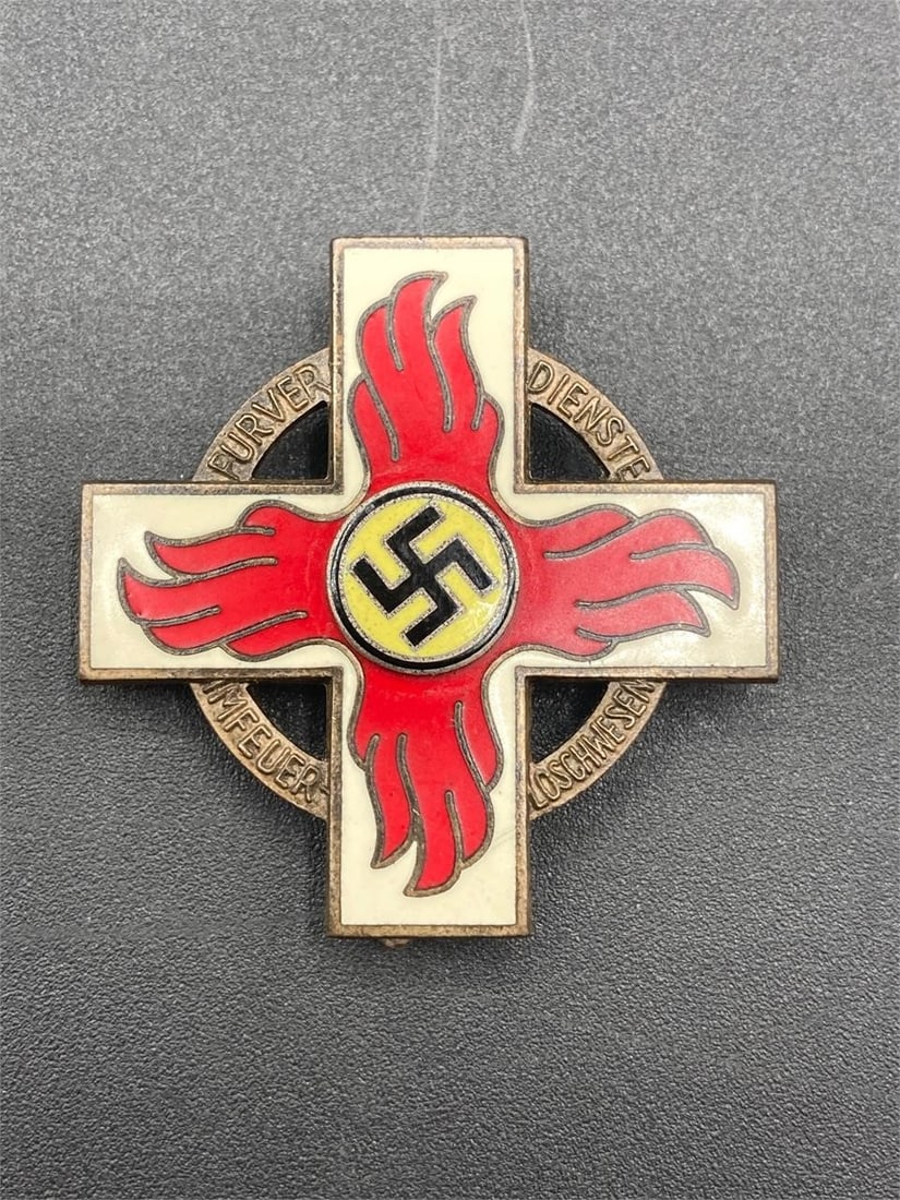 WWII German Fire Brigade Cross Medal: World war II German fire brigade cross 2nd class medal. Brass with enameled fire cross and NSDAP symbols. M9/72 mark noted on back on medal. Item is in very good condition.Measurements: 2" W, 2" L, 1"