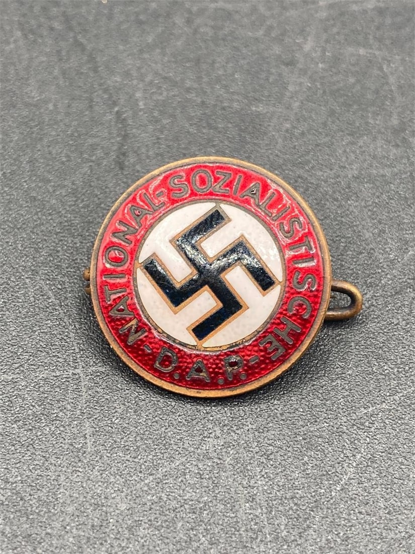 WWII German NSDAP Member Pin: World war II German NSDAP member pin. Enameled front with NSDAP symbol and NSDAP lettering. M1/129 and RZM stamps on back noted in photos. Measures 7/8". Pin in excellent condition.Measurements: 1" W,