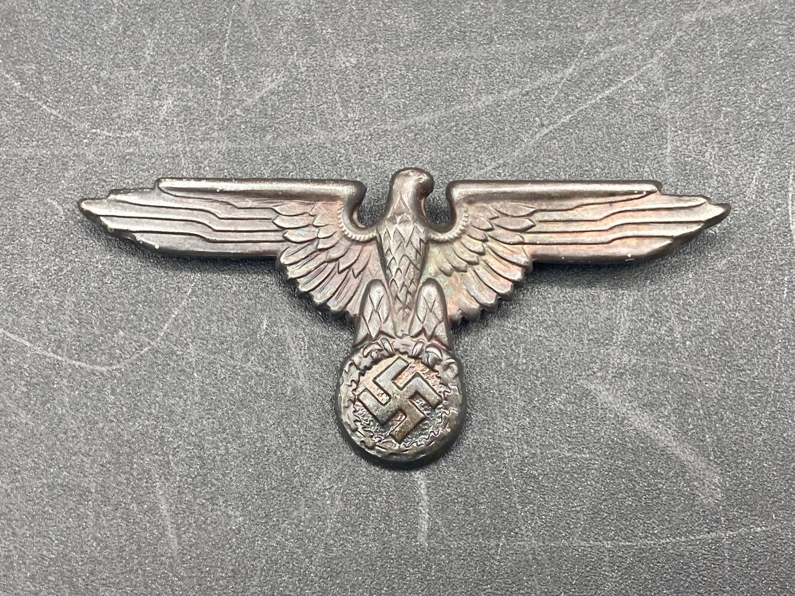 NSDAP Political Cap Eagle Pin: World war German NSDAP eagle political cap pin. RZM and M1/40 stamps on back noted in photos. Measures 2 3/4" long. Some light tarnishing, otherwise item is in good condition.Measurements: 1.5" W, 3" 