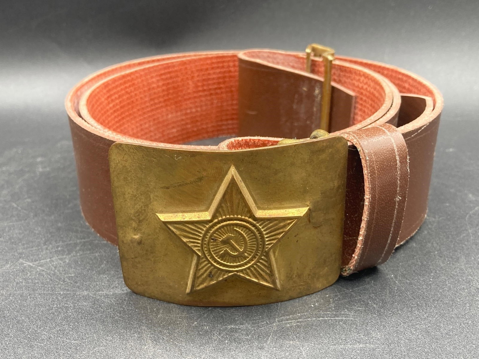 Vintage Soviet Union Ceremonial Ground Forces Belt: Vintage Soviet Union ceremonial ground forces belt. Brass belt buckle with Soviet hammer & sickle emblem on leather belt. Item is in good condition.Measurements: 5" W, 5" L, 2" H, 1 pound