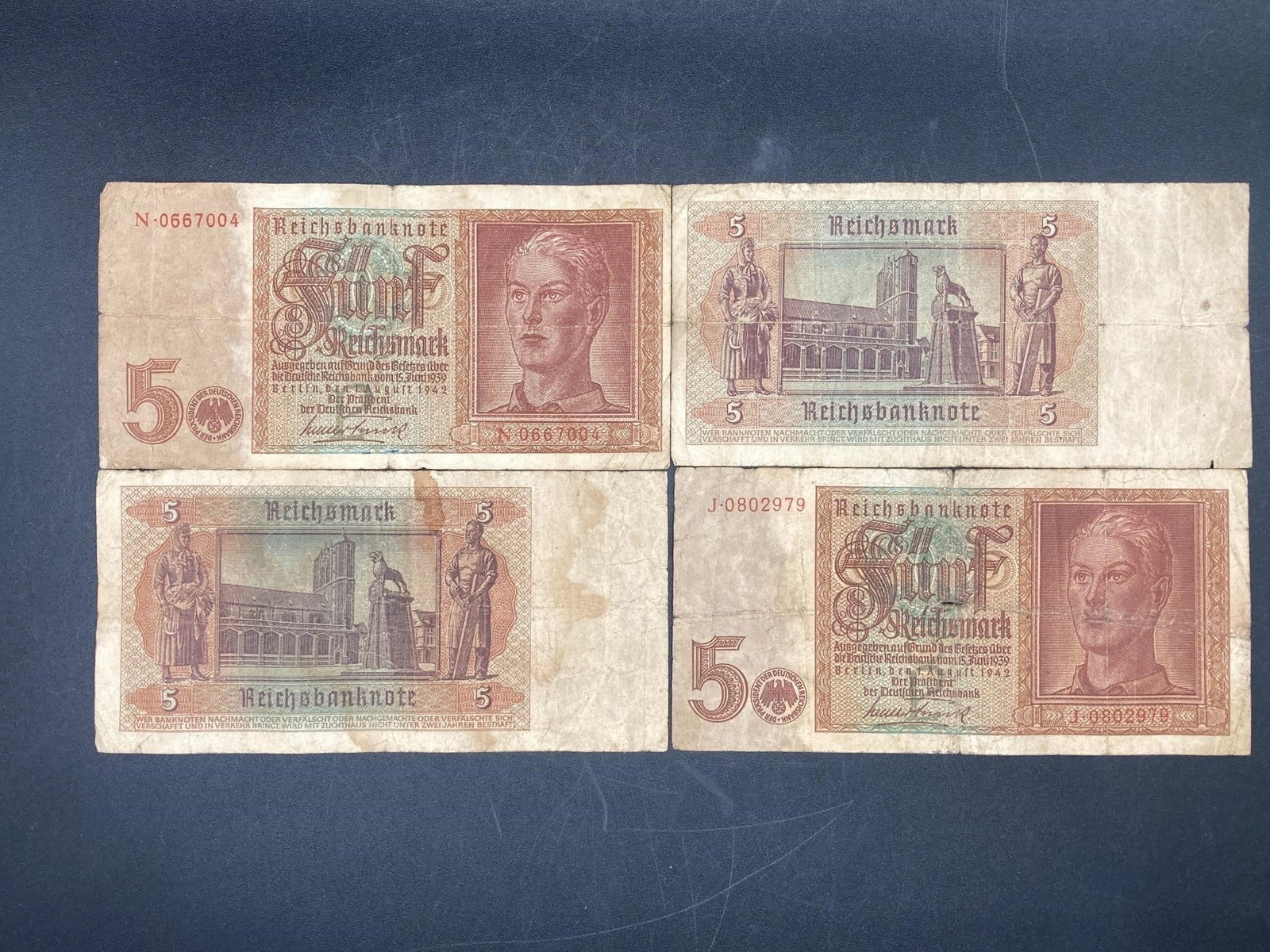 1942 German 5 Reichsmark Bank Notes: Set of four 1942 German 5 reichsmark bank notes. Dated August 1942. Ungraded, bills have wear and creasing.Measurements: 3" W, 7" L, 1" H, 1 pound
