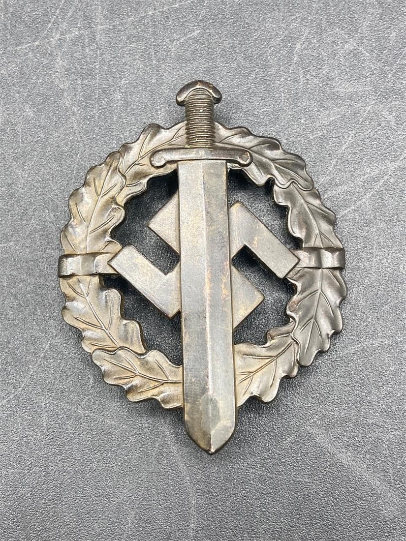 WWII German SA Sports Medal: World War II German SA sports badge. Bronze material with sword and NSDAP symbol. Stamps and numbers on back noted in photos. Measures 2.5" long. Some light wear, overall item is in very good conditio