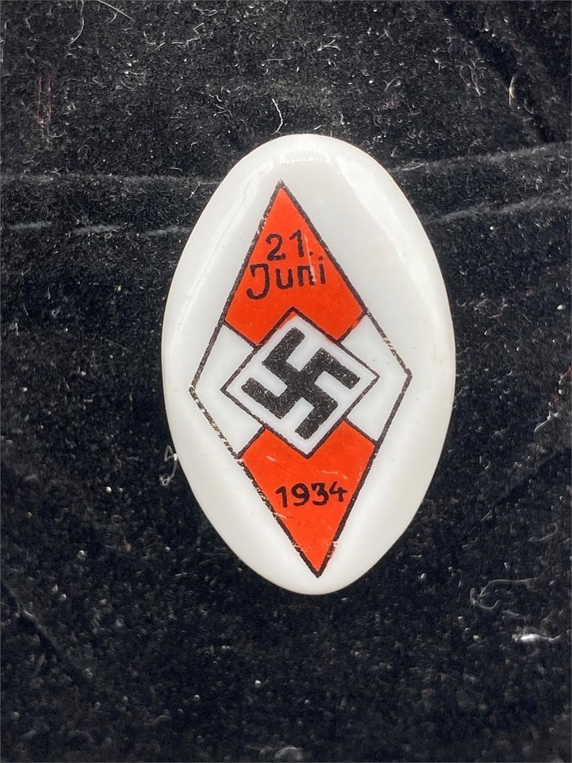 NSDAP 1934 Hitler Youth Festival Tinnie: German NSDAP 1934 Hitler youth festival tinnie pin. Porcelain material with painted front. Made for participation in the June 21, 1934 Hitler youth sports games and festival. Measures 1 1/4". Repair d
