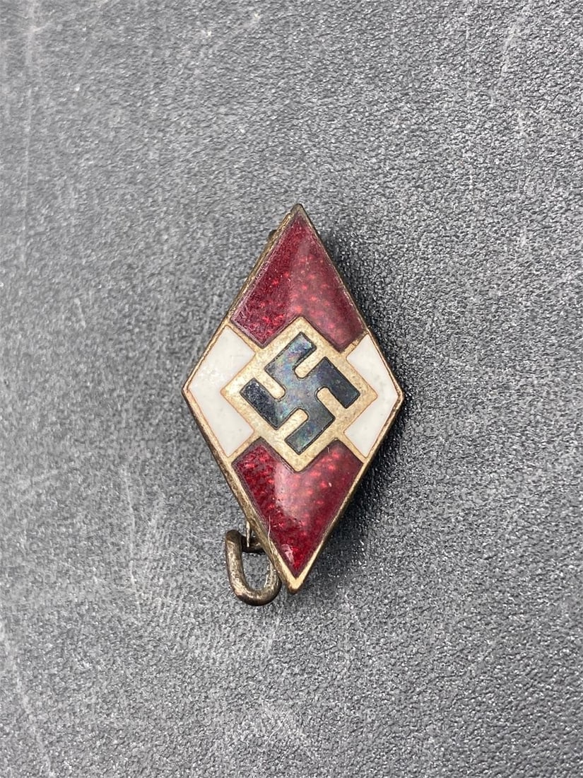WWII German Hitler Youth Member Badge: World War II German Hitler youth membership badge. Enameled front with NSDAP symbol at center. Shield shape. Measures 1" long. Badge is in excellent condition.Measurements: 1" W, 1" L, 1" H, 1 pound