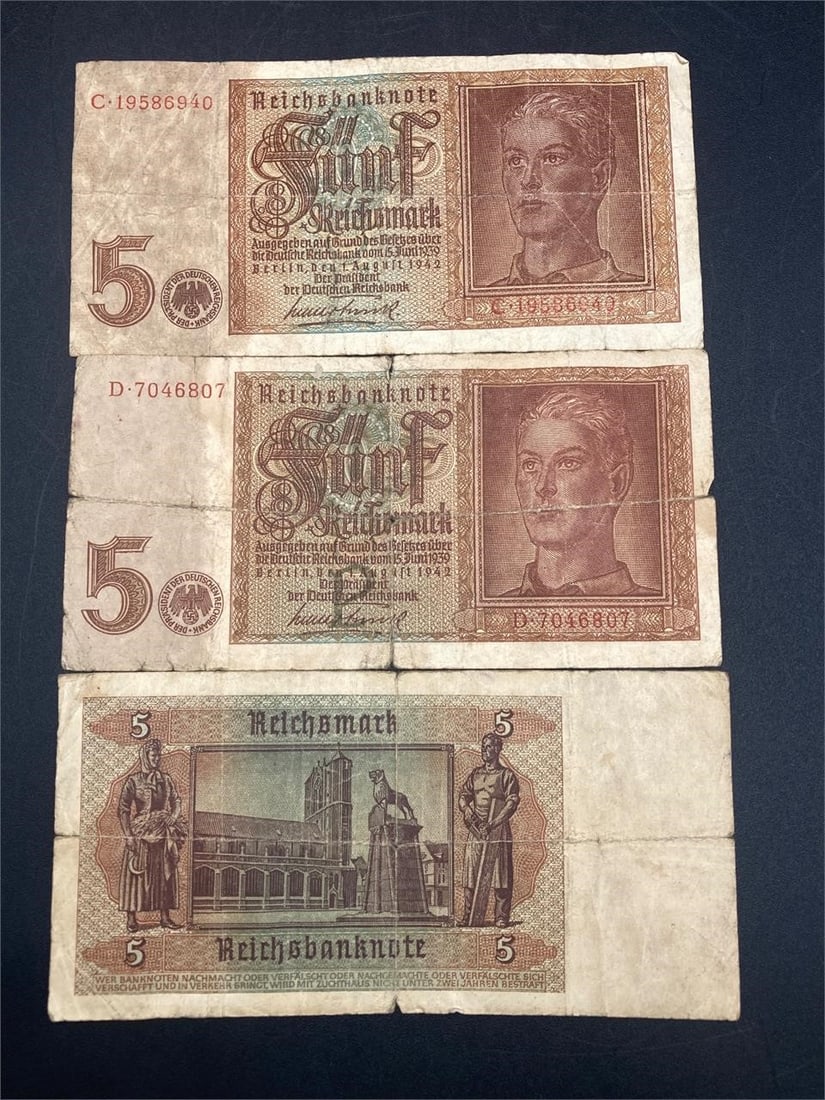 1942 German 5 Reichsmark Bank Notes: Set of three 1942 German 5 reichsmark bank notes. Ungraded, bills have wear, creases and some wrinkling.Measurements: 3" W, 7" L, 1" H, 1 pound