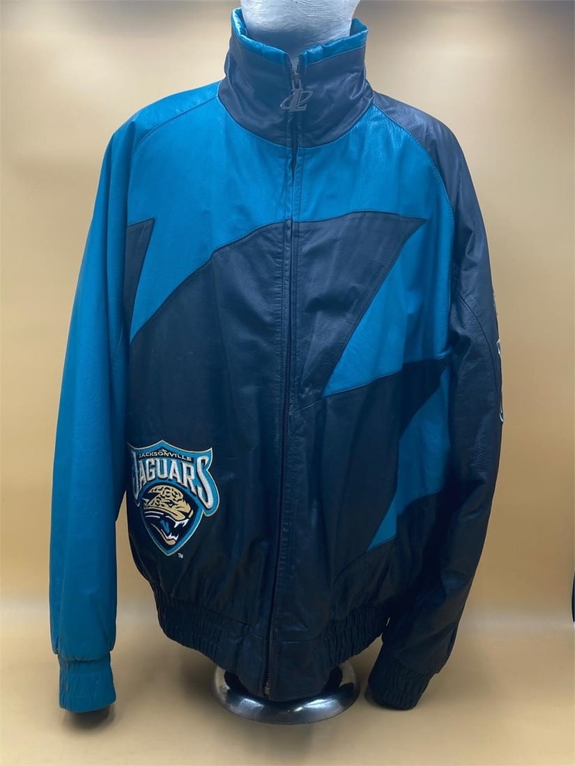 Vintage LogoAthletic Jacksonville Jaguars leather jacket. Features team graphics from the late 1990s: Vintage LogoAthletic Jacksonville Jaguars leather jacket. Features team graphics from the late 1990s and early 2000s. Black and teal color genuine leather exterior, padded nylon inner. Size extra larg