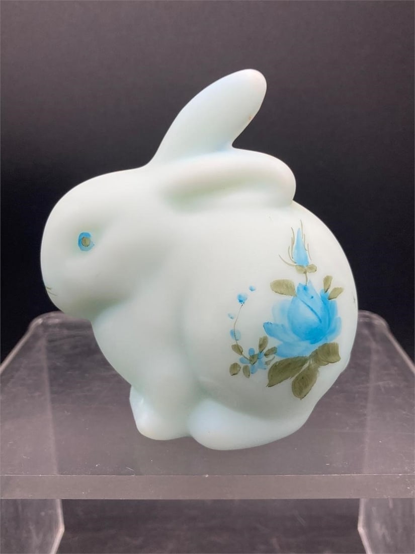 Vintage Fenton glass satin blue bunny figure. Features hand painted floral designs on pastel tones: Vintage Fenton glass satin blue bunny figure. Features hand painted floral designs on pastel tones blue glass. Measures 3" tall. Item is in good condition.Measurements: 3" W, 4" L, 3" H, 1 pound