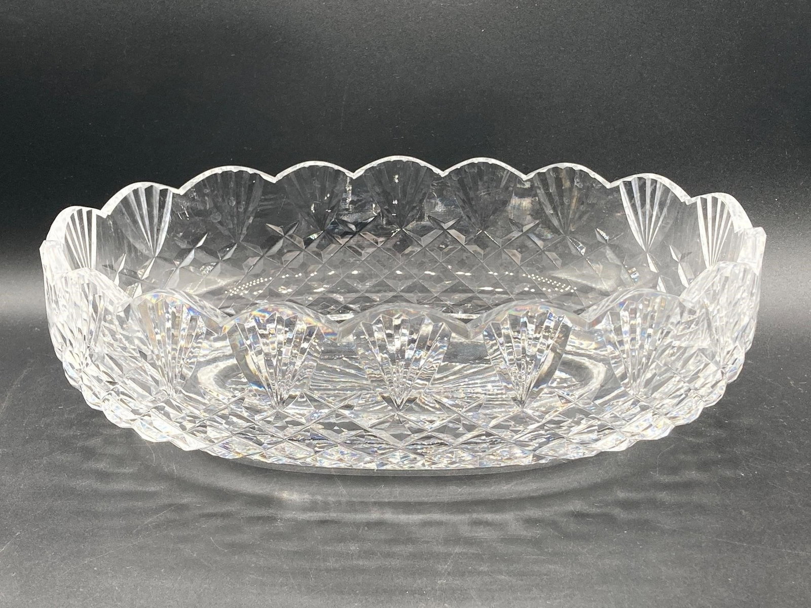 Waterford Crystal 11" glass heritage centerpiece bowl. Beautifully clear lead crystal glass with cut: Waterford Crystal 11" glass heritage centerpiece bowl. Beautifully clear lead crystal glass with cut geometric designs and scalloped rim. Waterford maker mark noted in photos. Measures 11" long. Item 