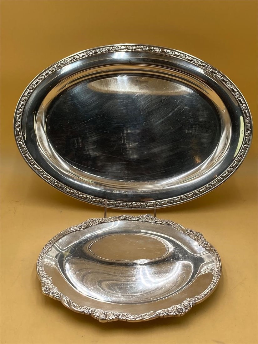 Set of two silver plated serving trays. Both trays feature floral designs on rims. Larger tray (1 of 6)