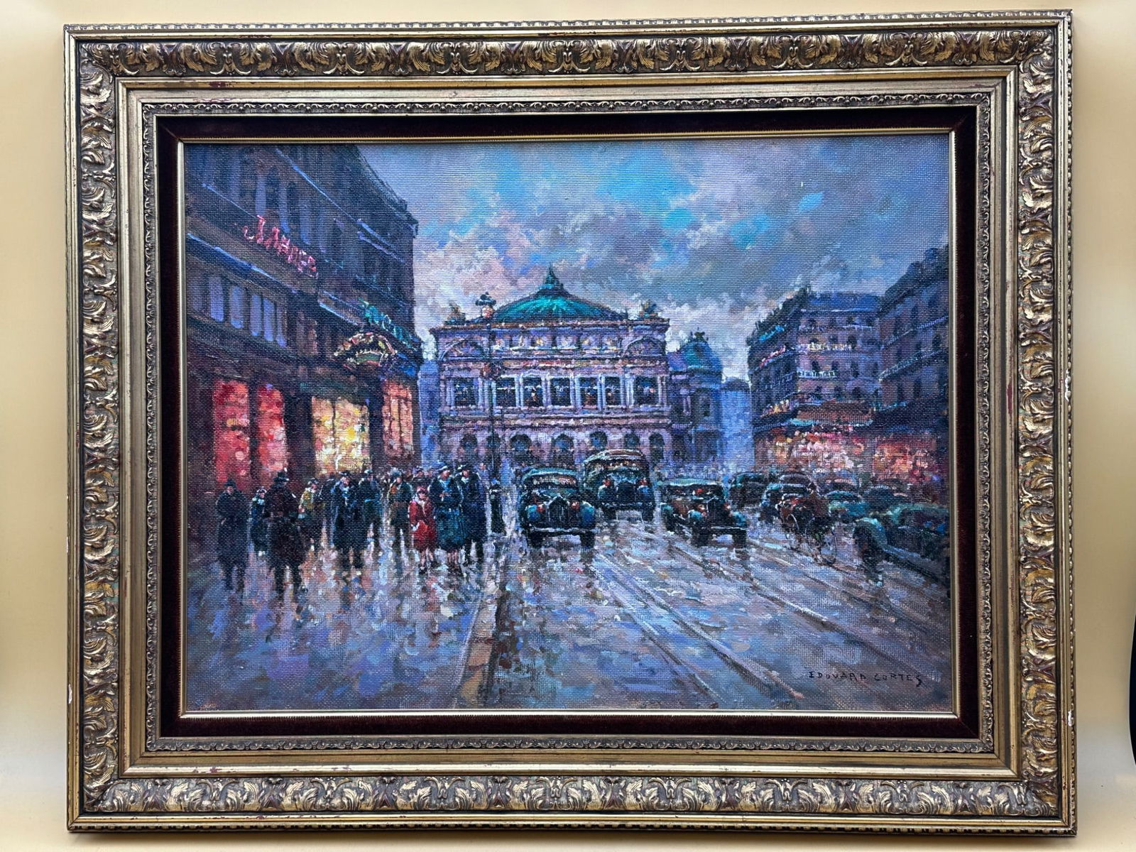 Edouard Cortes Oil Painting of Parisian Street Scene: This oil painting is attributed to Édouard Cortès and depicts a Parisian street scene featuring a lively cityscape, likely during the early 20th century. The artwork showcases carriages, pedestrians