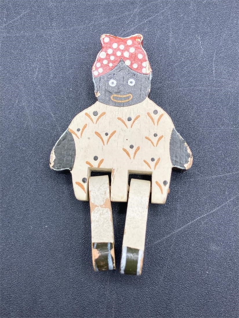 Vintage Black Americana Wood Ornament Magnet: Vintage black Americana wood ornament/magnet. Circa 1950s. Hand painted ornament with designs of the era. Can sit upright for desk use. Measures 2 3/4" long. Some light wear to areas of paint, otherwi