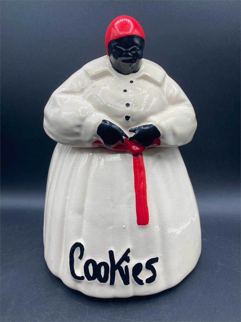 McCoy Pottery Black Americana Cookie Jar: Vintage McCoy pottery black Americana mammy porcelain cookie jar. Circa 1940s. Hand painted with designs of the era. Measures 10.5" tall. Item is in good condition.Measurements: 8" W, 8" L, 11" H, 5 p