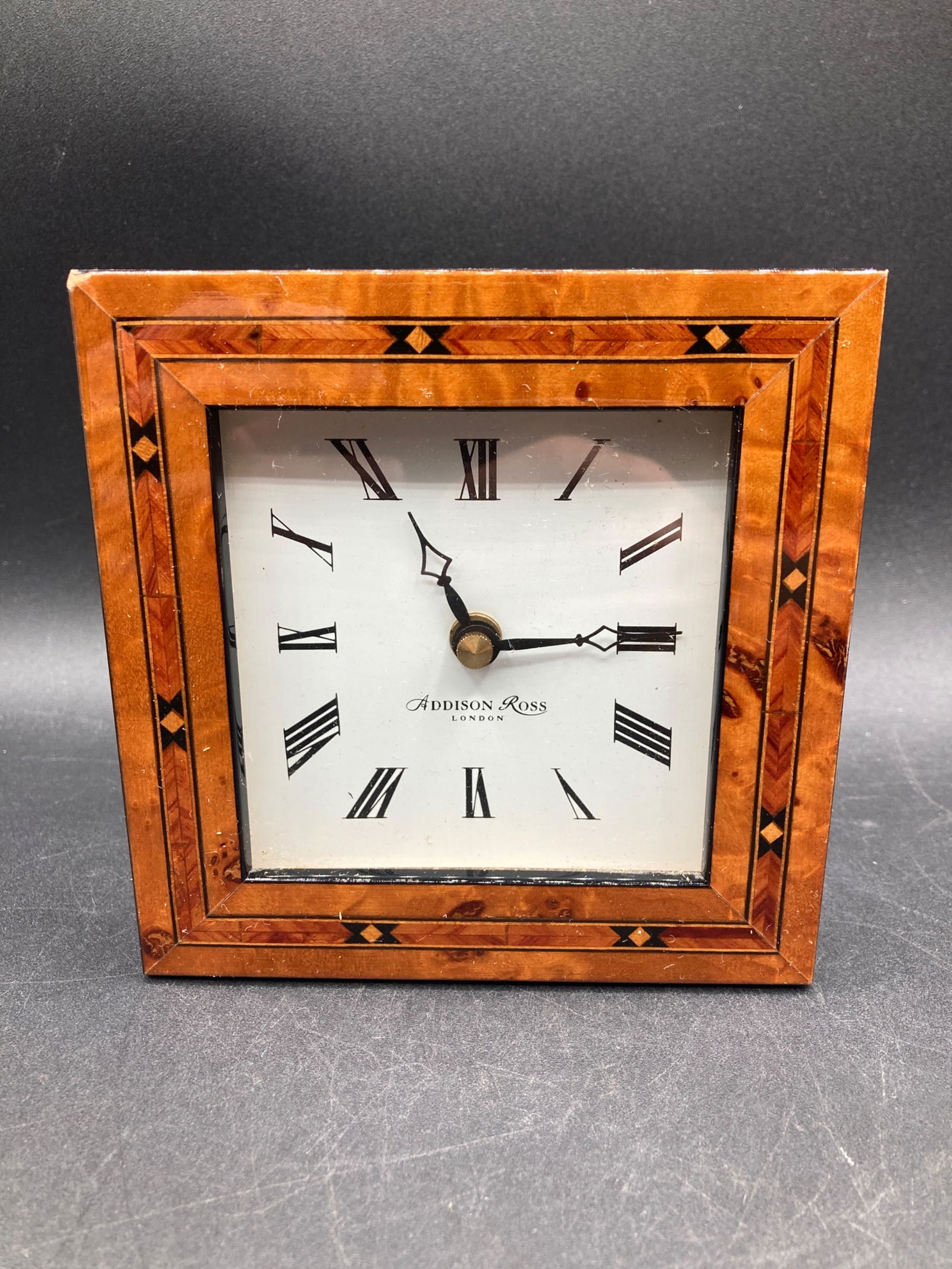 Addison Ross London Wooden Inlay Mantel Clock: This is an Addison Ross London mantel clock featuring a wooden inlay frame with geometric patterns. The clock face includes Roman numerals and is marked with "?Addison Ross London.' The frame's outer