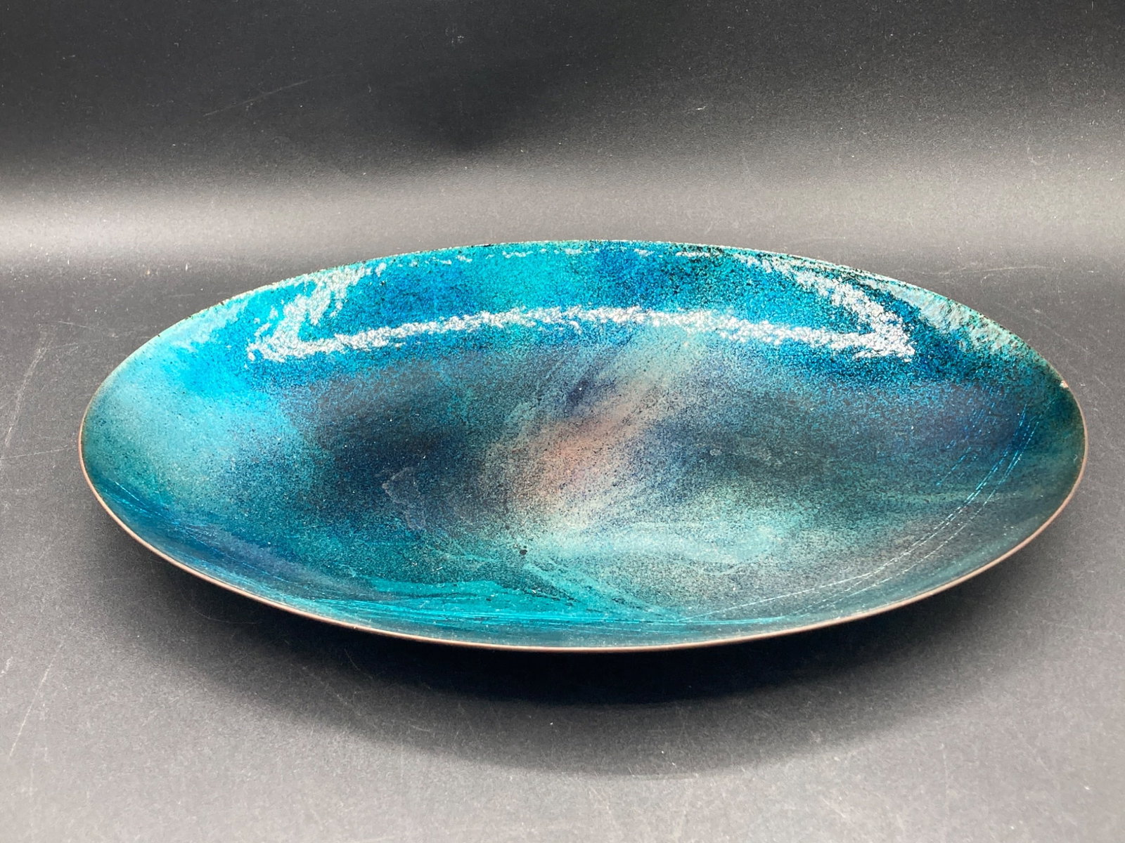 10" Peg Miller Enameled Plate: This listing features a handcrafted enamel plate by Peg Miller, measuring 10 inches in length. Created in Wayne, NJ, USA, this item showcases intricate techniques of enamel artistry. The vibrant desig