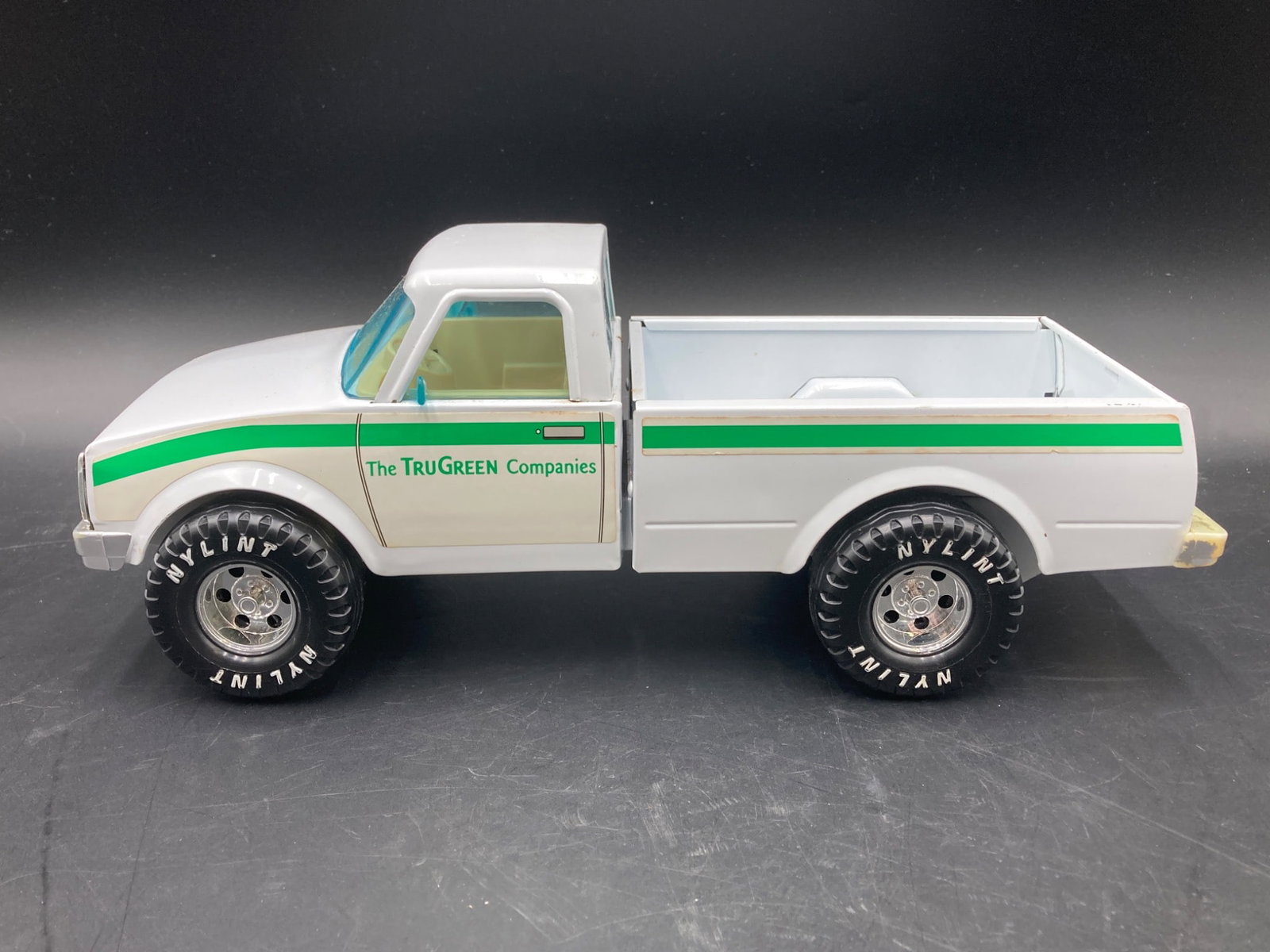 2002 Funrise TruGreen Toy Truck: This is a vintage 2002 die-cast toy truck manufactured by Funrise Inc. The model is branded with 'The TruGreen Companies' logo, making it a collectible promotional advertisement piece. The truck is mo