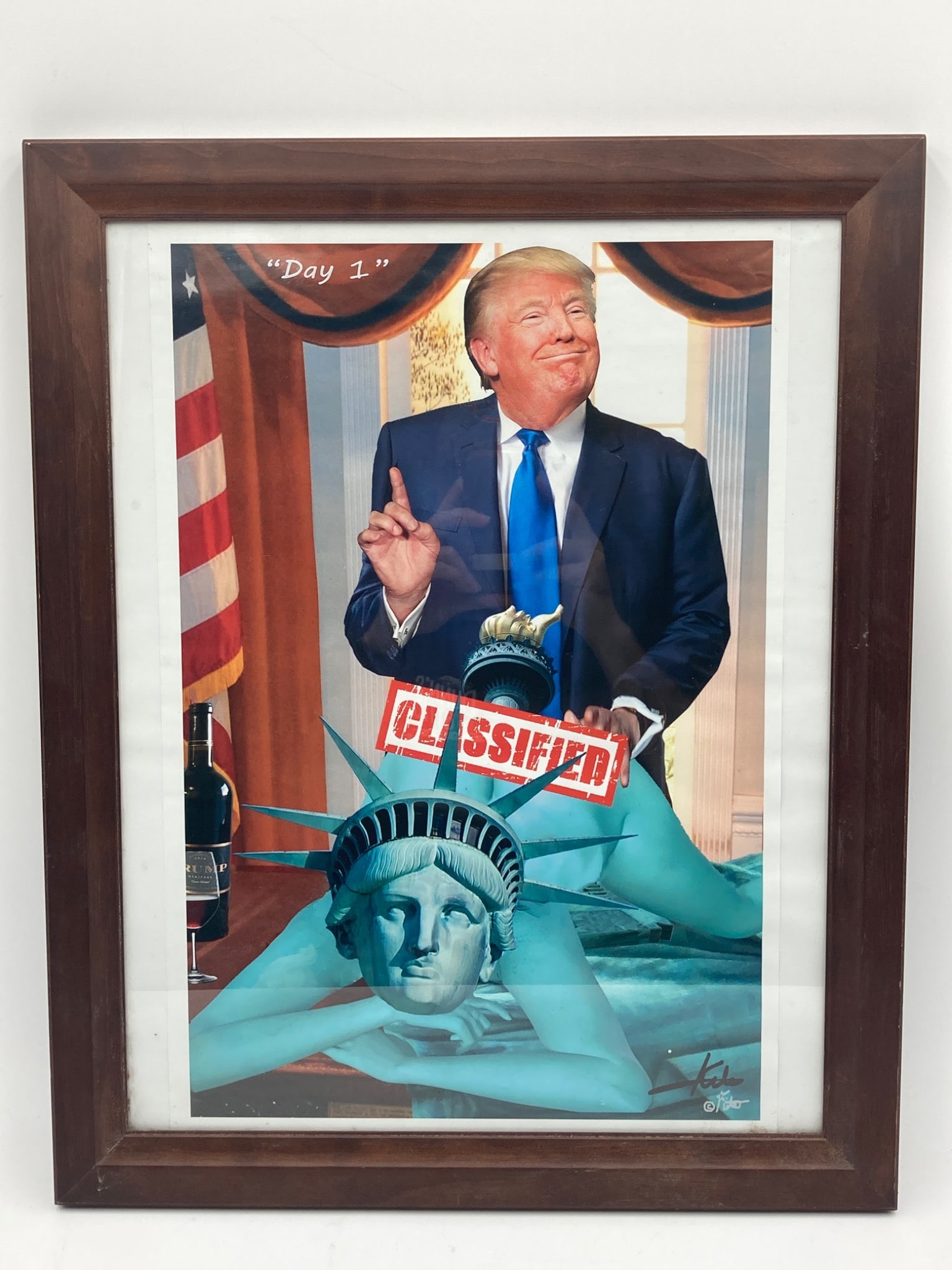 Donald Trump Political Satire Print Signed By Artist: This item is a framed artwork featuring a Donald Trump political satire theme. The piece is signed by the artist and includes imagery featuring prominent political symbols, including the Statue of Lib