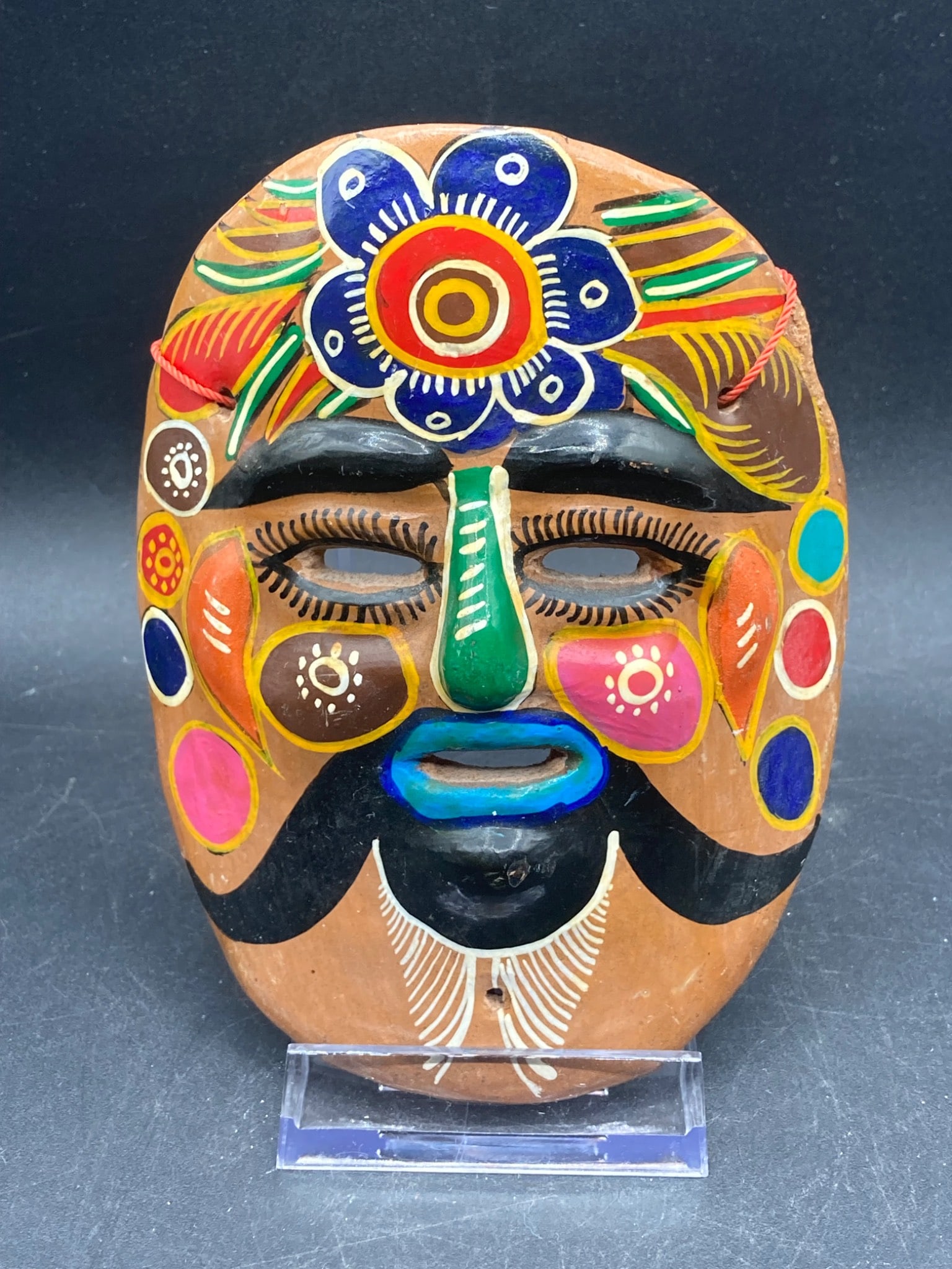 Vintage 5" Mexican Folk Art Hand Painted Mask: This is a vintage Mexican folk art mask, measuring approximately 5 inches in height. The piece is hand-painted with detailed floral and geometric patterns in vibrant colors such as red, blue, green, y