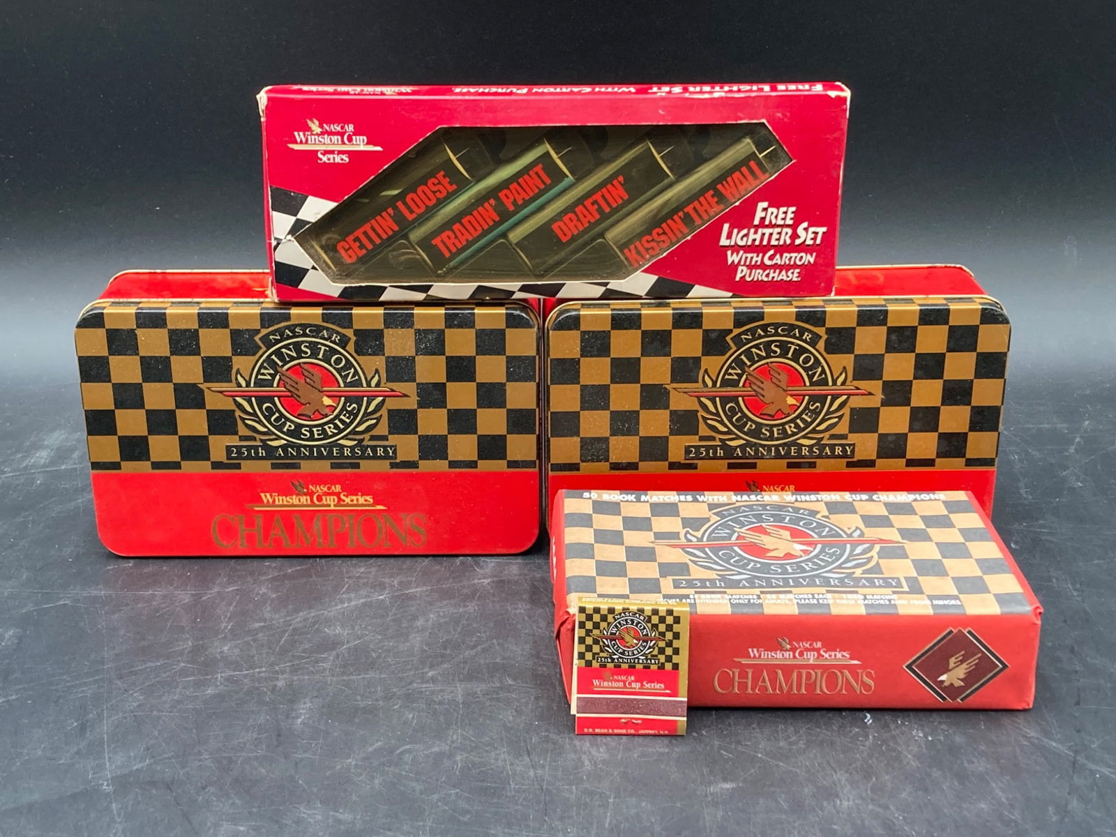 NASCAR Winston Cup Series 25th Anniversary Matchbook & Lighter Set: This Winston Cup Series 25th Anniversary collectible set includes a total of 50 matchbooks, each celebrating iconic NASCAR champions, such as Terry Labonte, from 1984. Manufactured by D.D. Bean & Sons