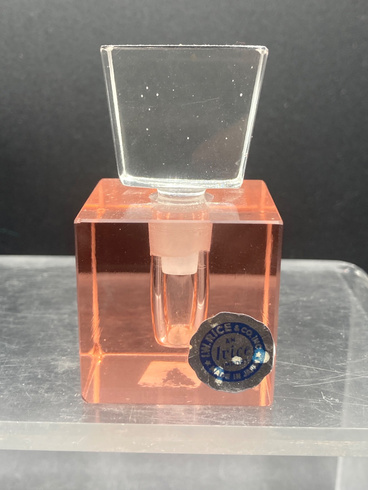 Vintage Irice Pink Cube Perfume Bottle: This is a vintage pink cube perfume bottle manufactured by Irice & Co. The bottle features an original glass stopper and maintains its original Irice import label indicating it was made in Japan. The 