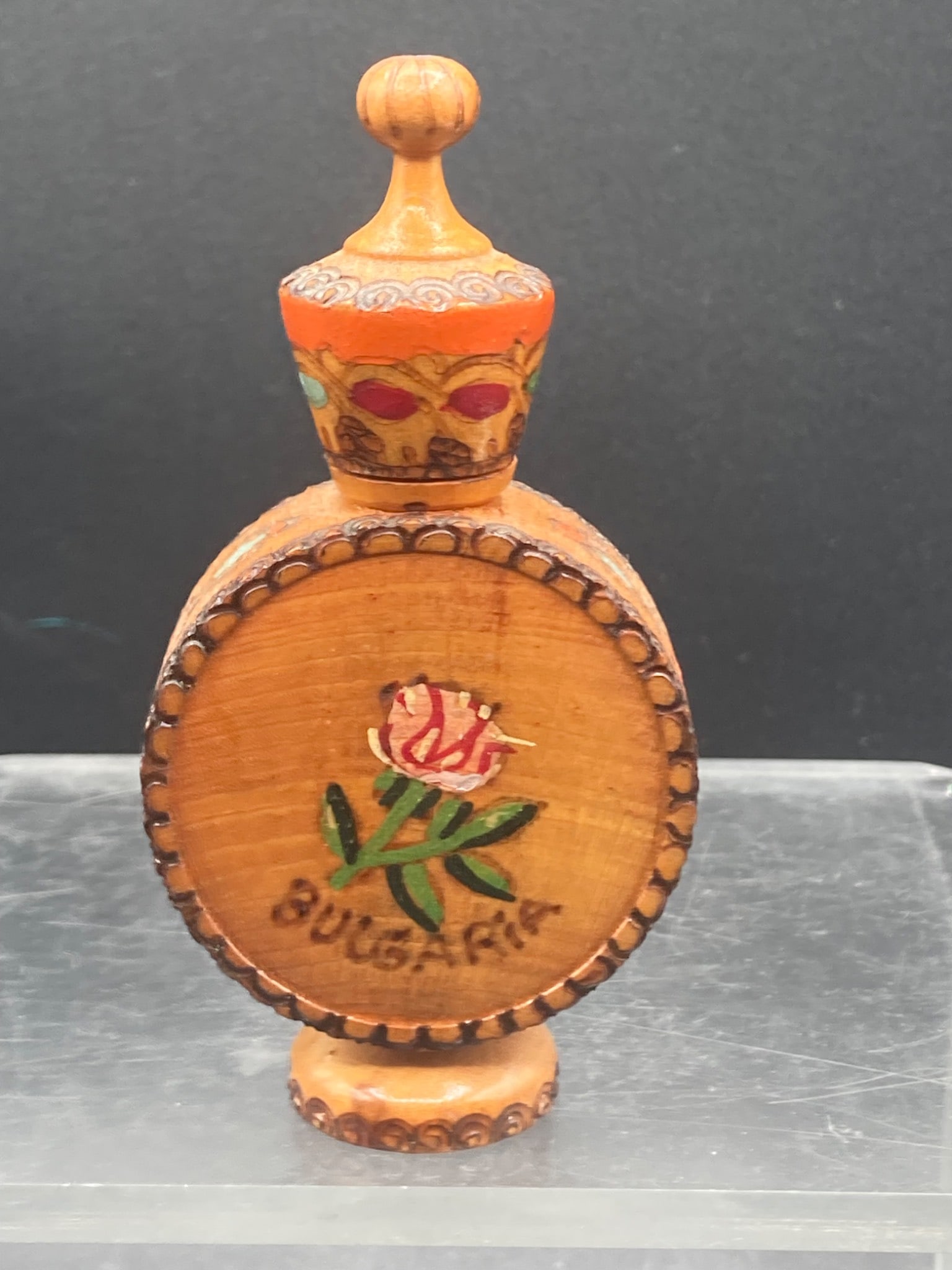 Vintage Bulgarian Wooden Rose Oil Bottle: Wooden bottle originating from Bulgaria, designed to store rose oil. Features hand-painted decoration, including a rose motif with the inscription ˜Bulgaria™ on one side and a geometric floral desi