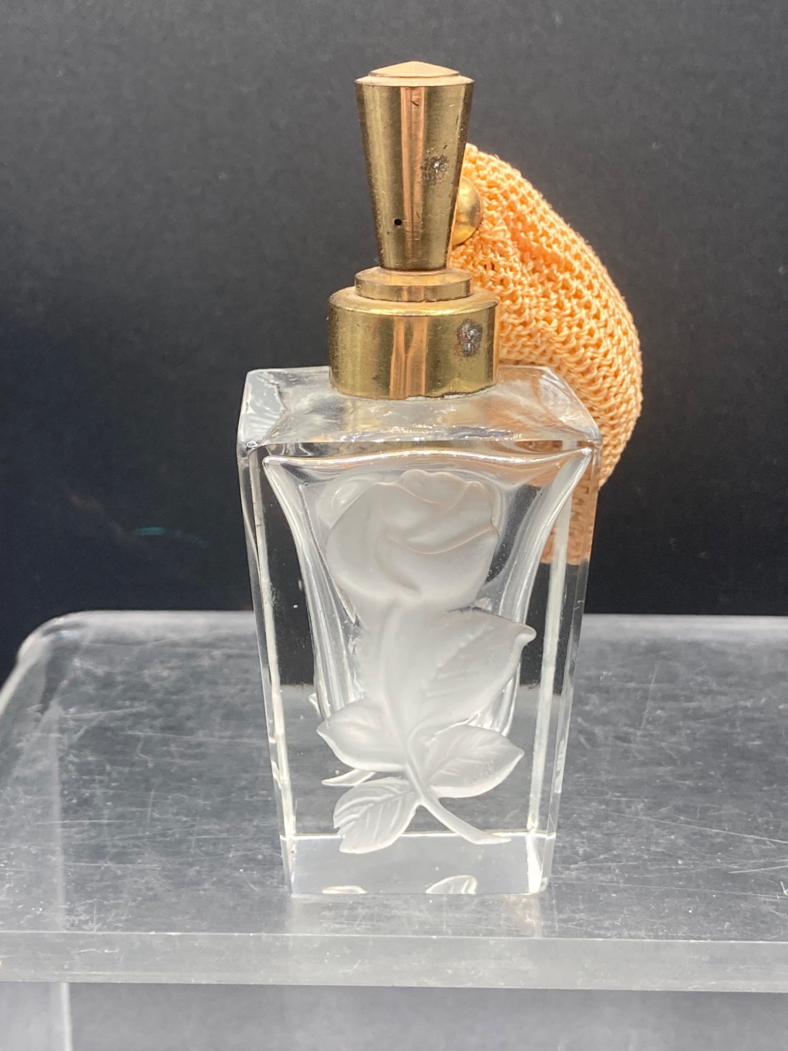 Vintage Satin Glass Rose Atomizer Perfume Bottle: This is a vintage satin glass atomizer perfume bottle featuring a rose design etched on the glass. The hardware is composed of brass, and the atomizer includes a woven fabric bulb in a tan color. The