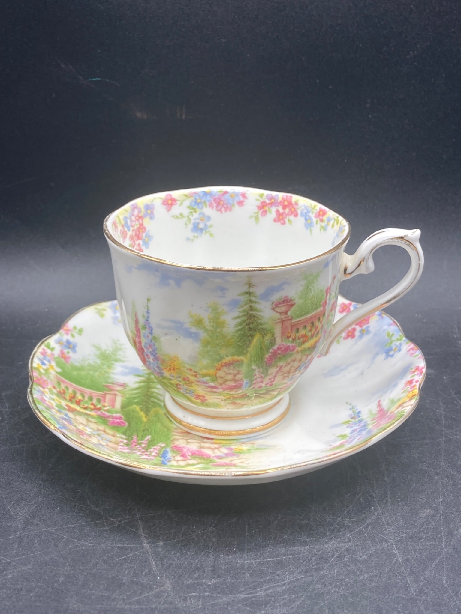 Royal Albert Bone China ˜Kentish Rockery™ Tea Cup & Saucer: This listing features a Royal Albert bone china tea cup and saucer in the ˜Kentish Rockery™ pattern. The set is marked with ˜Royal Albert Bone China, Kentish Rockery, Reg. No. 810696, England.™