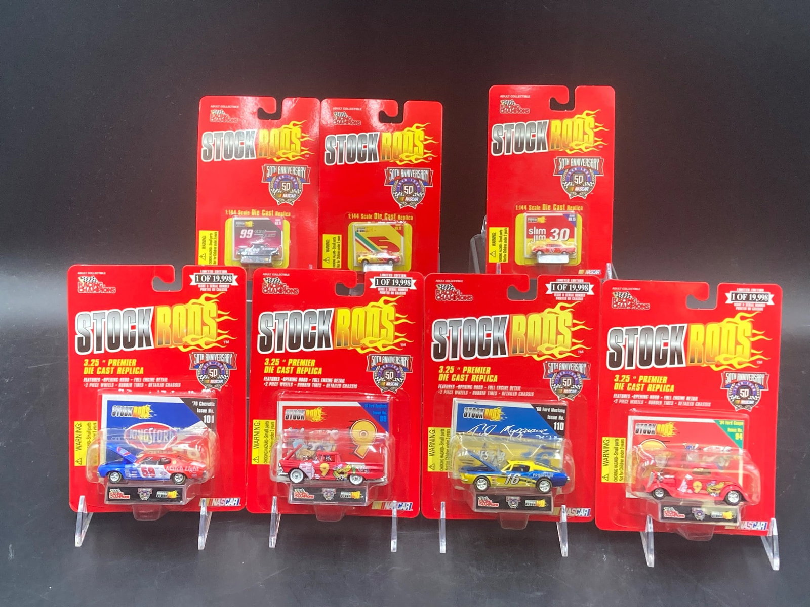 Racing Champions Stock Rods NASCAR Die Cast Set: This lot features a collection of Racing Champions Stock Rods die-cast replicas. Included are seven pieces, each celebrating NASCAR's 50th Anniversary. The set includes multiple models in scales of 1: