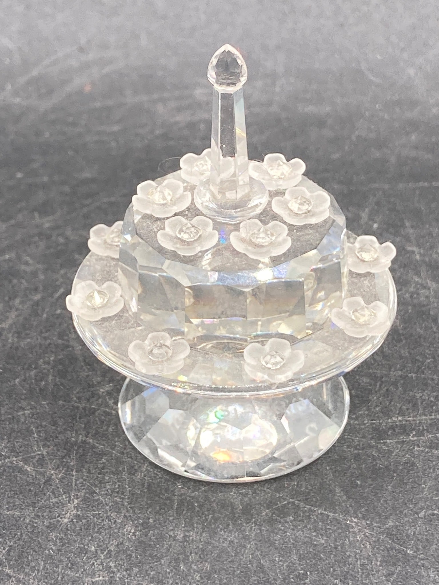 Swarovski Miniature Cake Crystal: This is a Swarovski SCS crystal miniature cake, featuring a faceted design with flower accents. The etched markings on the base indicate 'SCS' and '1987-1992.' It is made entirely of clear Swarovski c