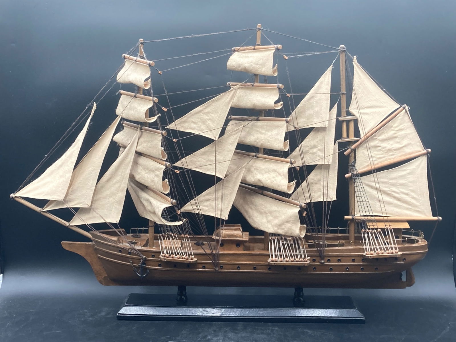 Handmade 32 Wooden Bluenose Clipper Ship Model: This is a handmade 32-inch wooden model of a Bluenose clipper ship. Crafted with attention to detail, the model features multiple sails, rigging, and a detailed wooden deck design. It is mounted on a