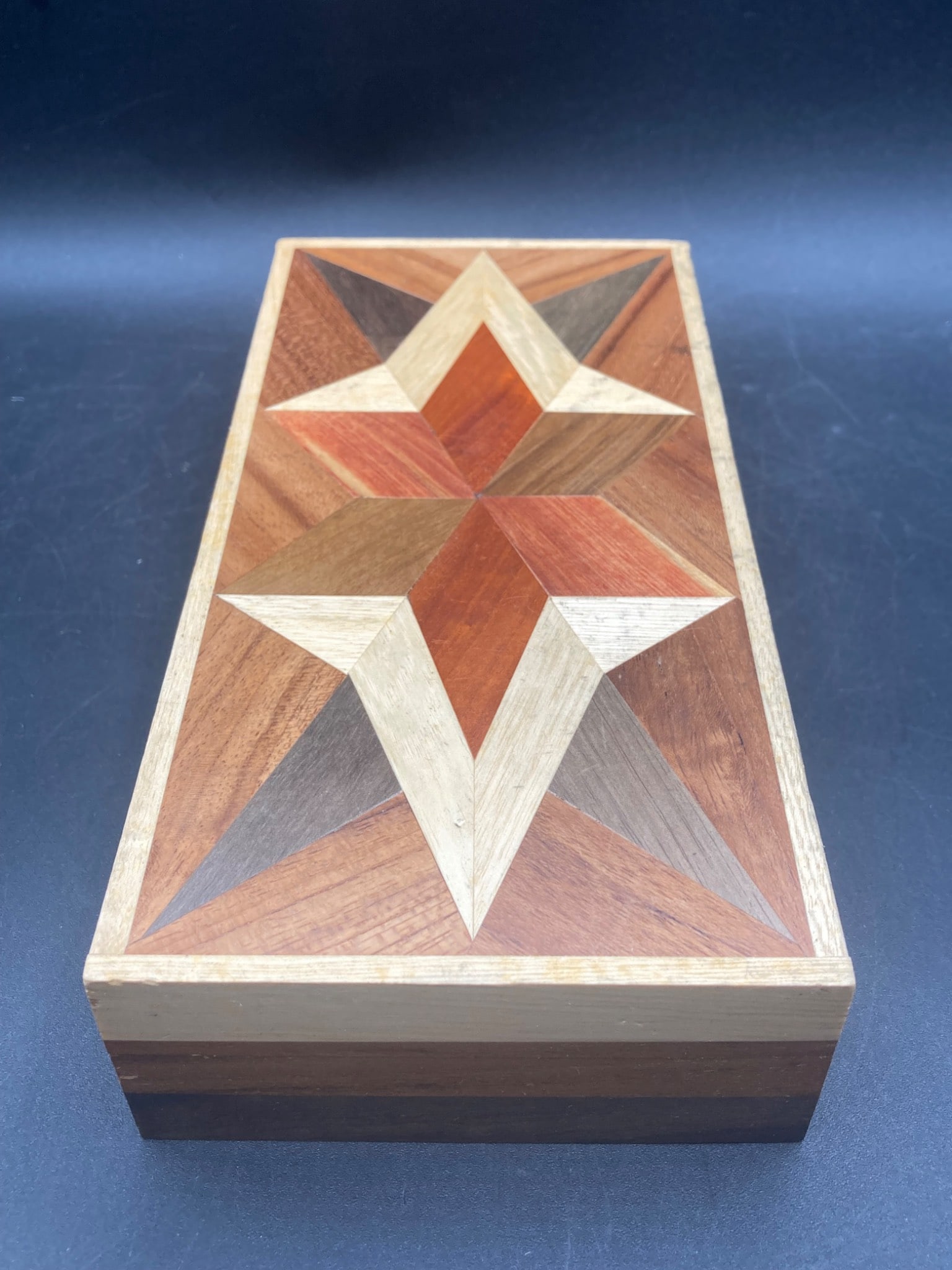 9 Wood Marquetry Box: This is a rectangular wooden box featuring a geometric star pattern created using a marquetry technique. The box measures approximately 9 inches in length, as depicted with a measurement tape. The lid