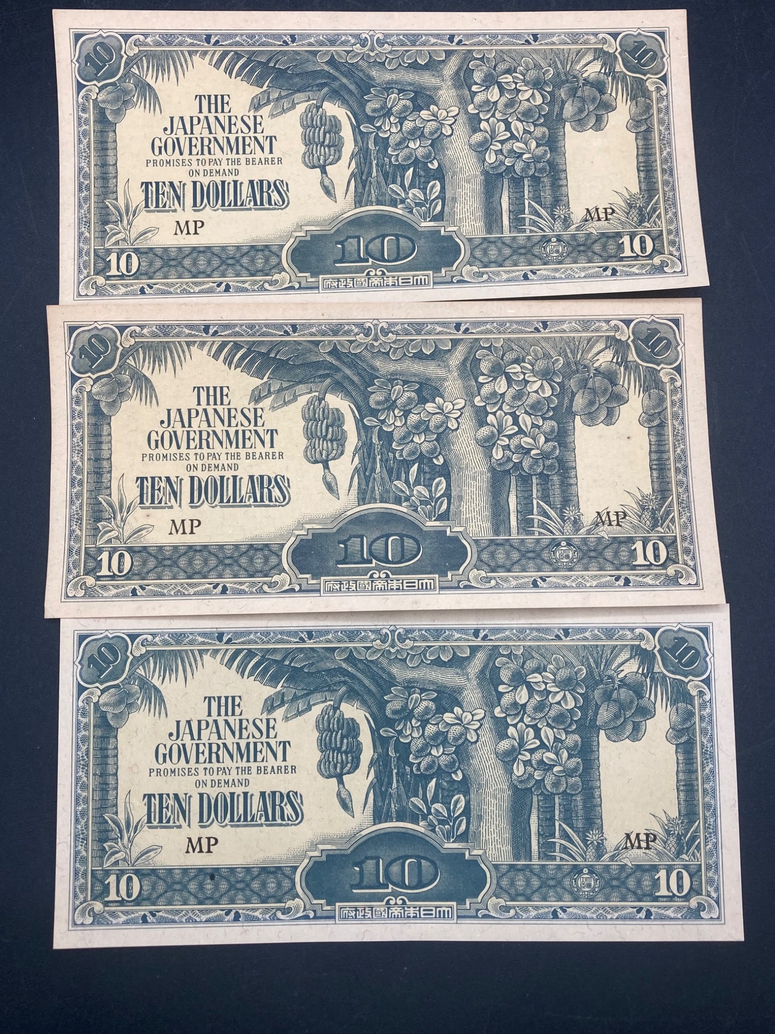 WWII Era Japanese Occupation Malaysia 10 Dollar Notes: Set of three WWII-era Japanese Occupation currency notes from Malaysia, each with a face value of 10 dollars. The notes feature the series designation 'MP' and were issued during the Japanese Occupati
